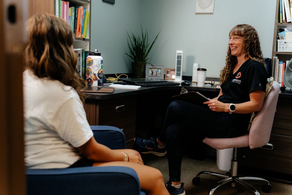Laura consulting with a patient