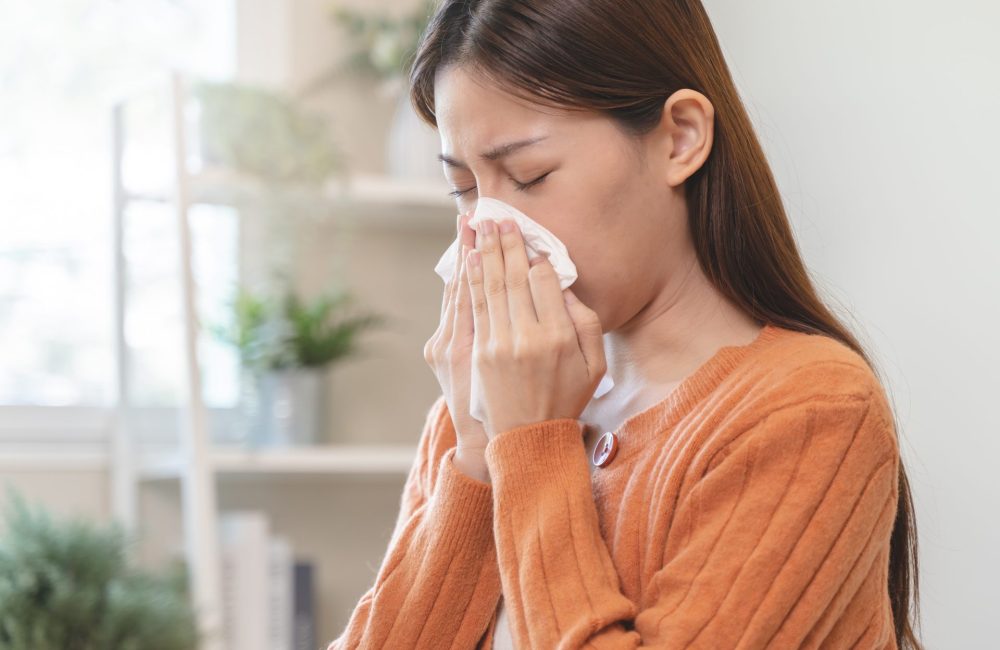 Woman blows her nose after encountering indoor allergen