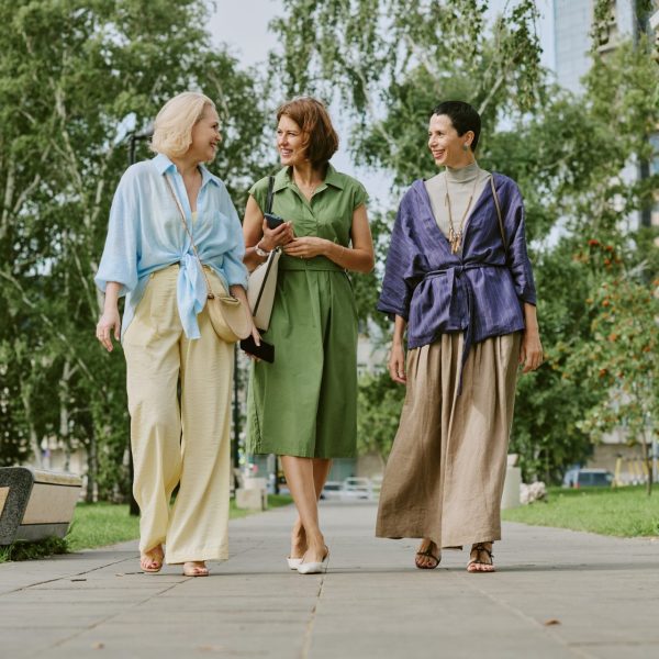 Three middle aged woman discuss BHRT outdoors while on walk