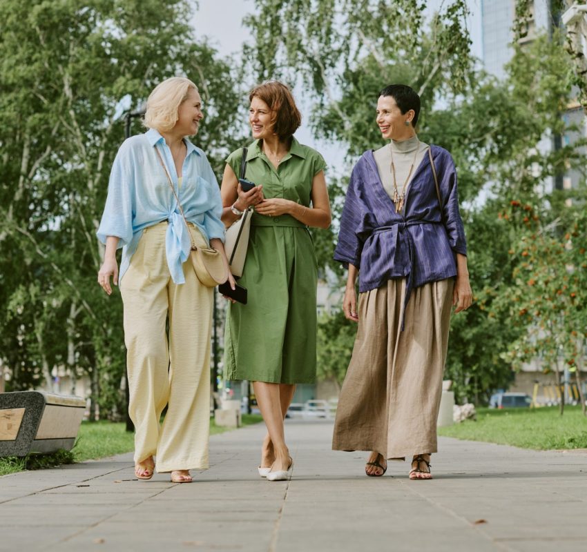 Three middle aged woman discuss BHRT outdoors while on walk