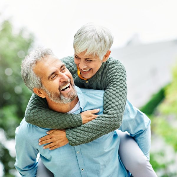 Older woman hugging man after discussing Bioidentical Hormone Replacement Therapy, BHRT