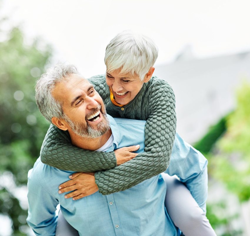Older woman hugging man after discussing Bioidentical Hormone Replacement Therapy, BHRT