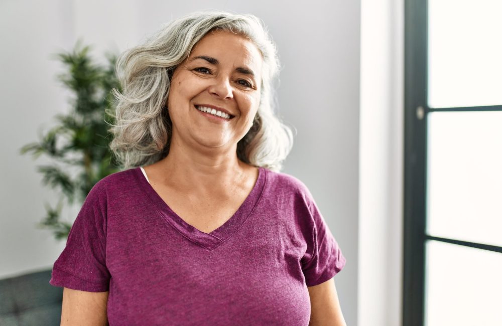 Woman with pink shirt talks breast cancer awareness