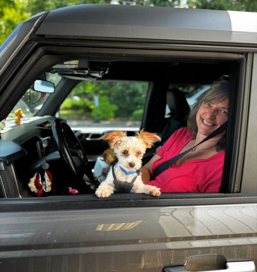 Woman at Warren's Drug Store in car with dog