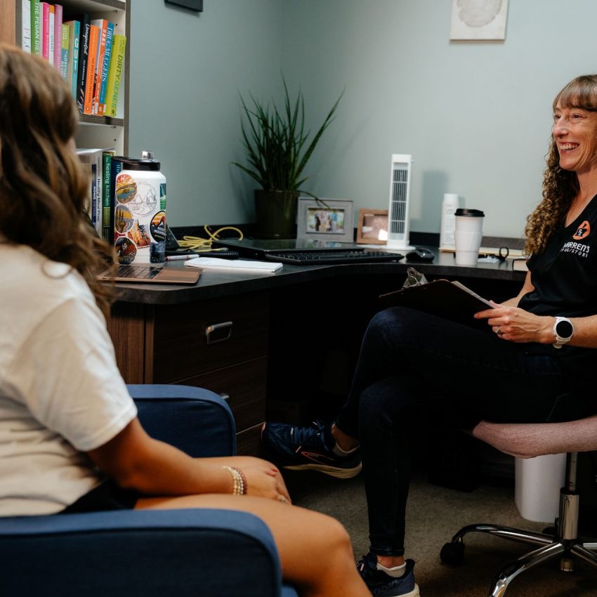 Laura consulting with a patient