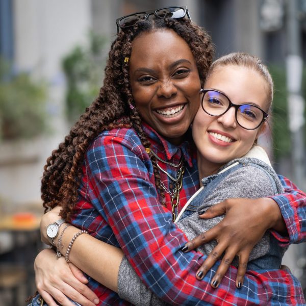 Two woman hug after learning about 14 day hormone detox