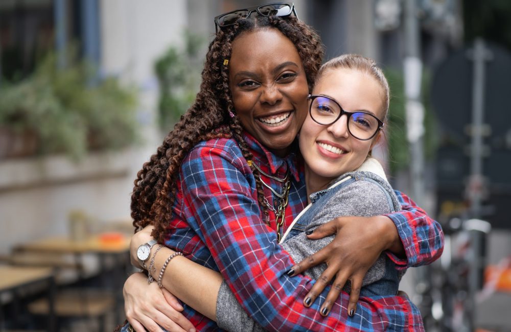 Two woman hug after learning about 14 day hormone detox