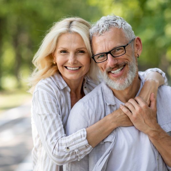 Couple smiles outdoors after discussing erectile dysfunction