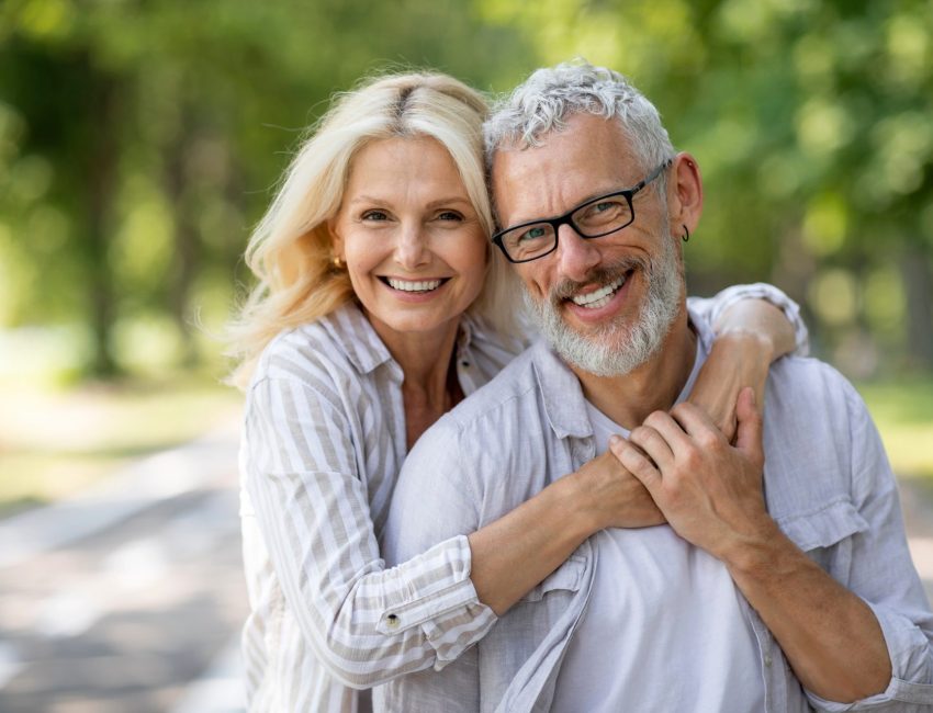 Couple smiles outdoors after discussing erectile dysfunction