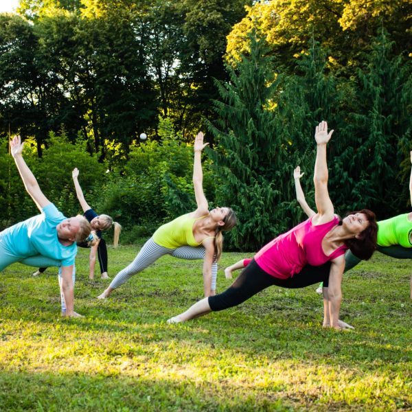 Women stretch in park after learning about high cortisol