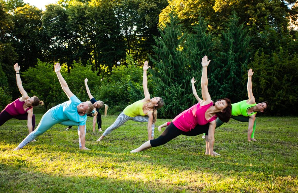 Women stretch in park after learning about high cortisol