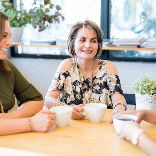 Three middle age women talk about hormone replacement at table