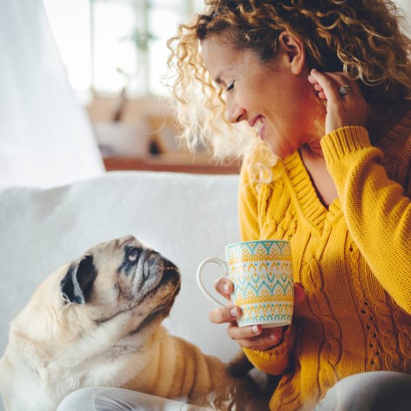 Woman home with pet dog after doing hormone test