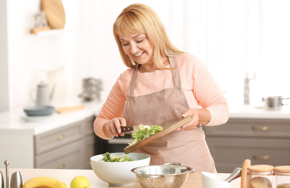 Woman cuts veggies to get the most out of fiber for weight loss