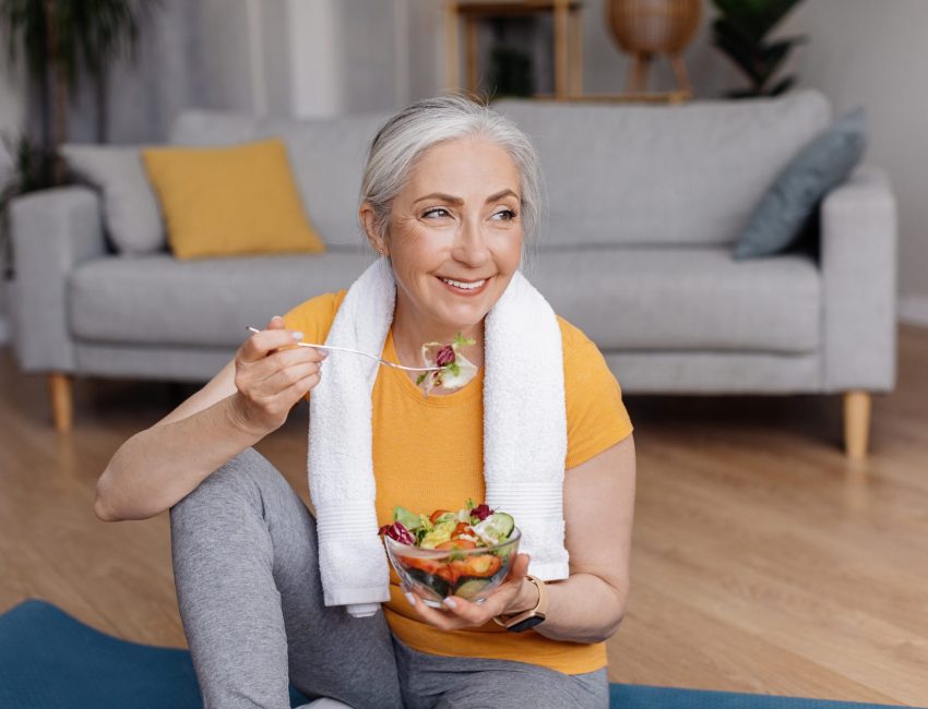 Woman eating salad to replace nutrients