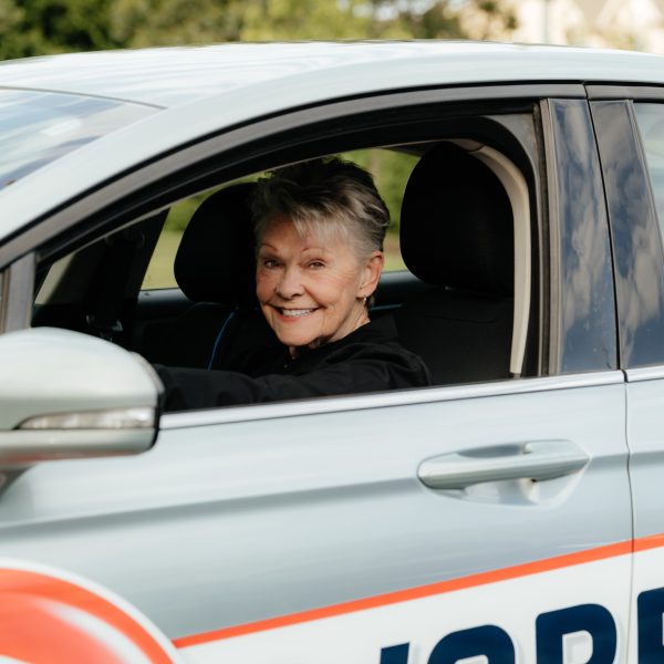 Woman driving car for Warren's drug store prescription delivery