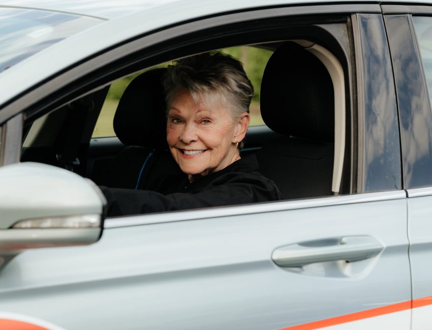 Woman driving car for Warren's drug store prescription delivery
