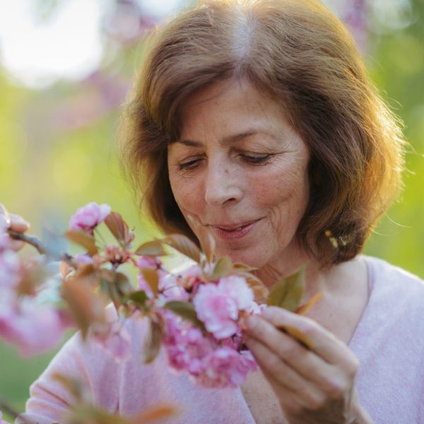 Woman smells flower near Green Level