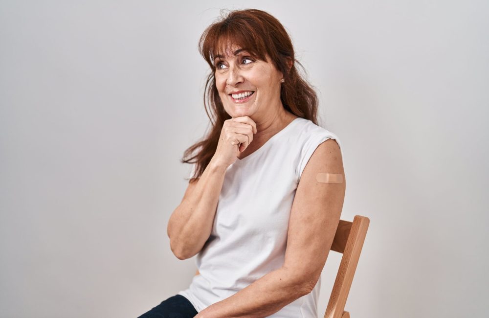 Older woman with Band-Aid getting shingles vaccine