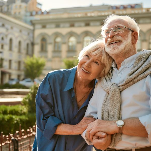 Older couple on vacation in European court yard after getting travel vaccinations
