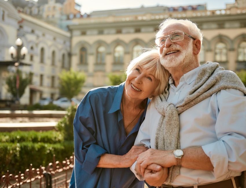 Older couple on vacation in European court yard after getting travel vaccinations
